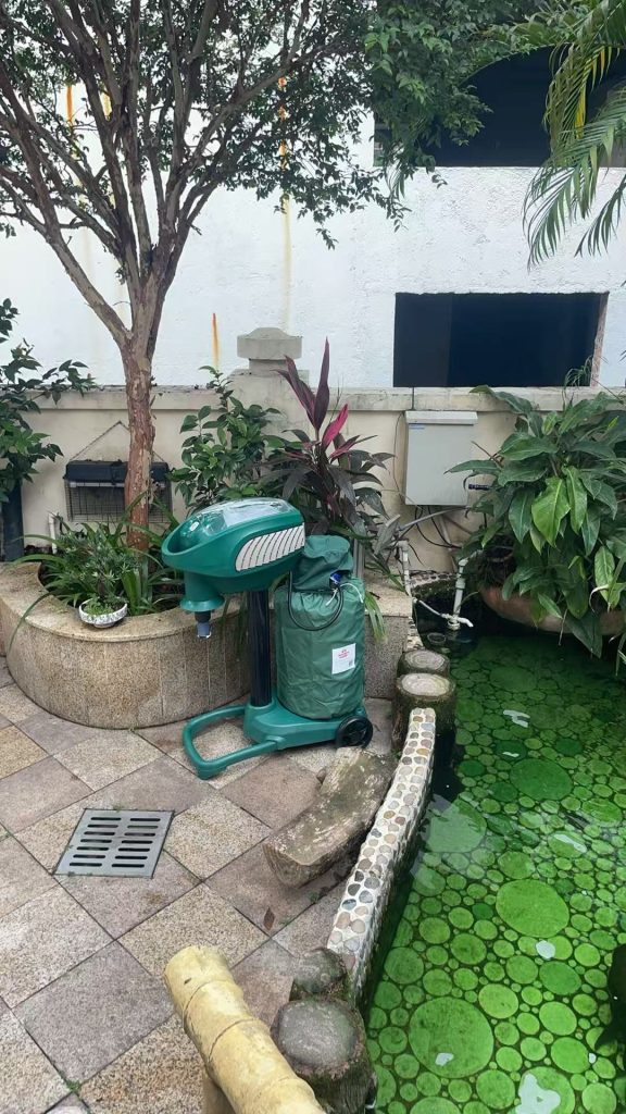 MM3300 Large-Area Mosquito Trap positioned in an existing outdoor garden setting